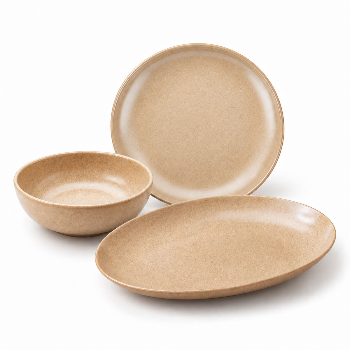 Three-piece beige rice-husk dinnerware set including a shallow bowl, a round plate, and an oval platter, shown on a clean white background.