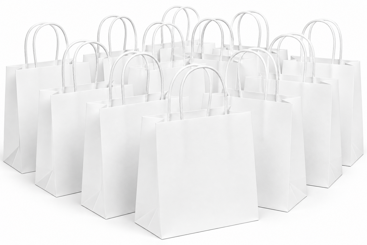 A group of blank white paper shopping bags with white paper handles, arranged in rows on a seamless white background.