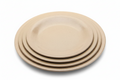 A stack of four nested round rice-husk plates in a light beige speckled finish, isolated on a white background.