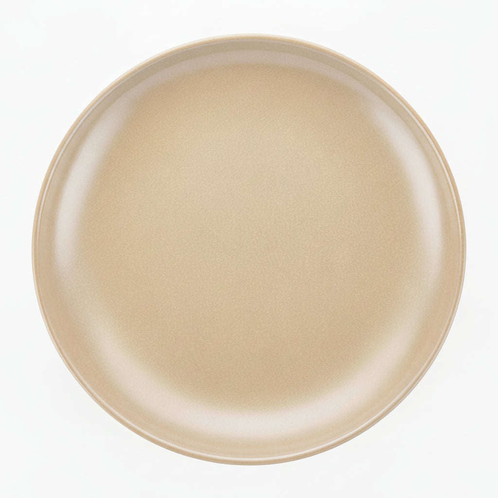 A round ceramic plate in a matte champagne beige color, photographed from directly above on a solid white background.
