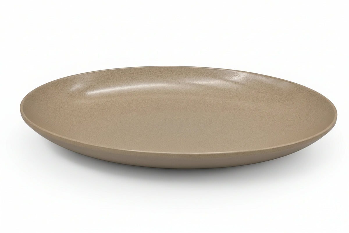A minimalist, shallow oval ceramic plate in a matte taupe-brown glaze, shown from a high-angle perspective on a clean white background.
