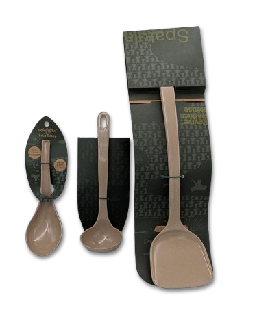 A set of three rice-husk utensils in a light tan color, including a spatula, spoon, and ladle, shown with their dark green packaging against a white background.