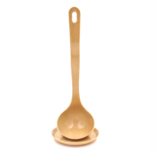 A beige or light brown serving ladle with a matching small saucer.