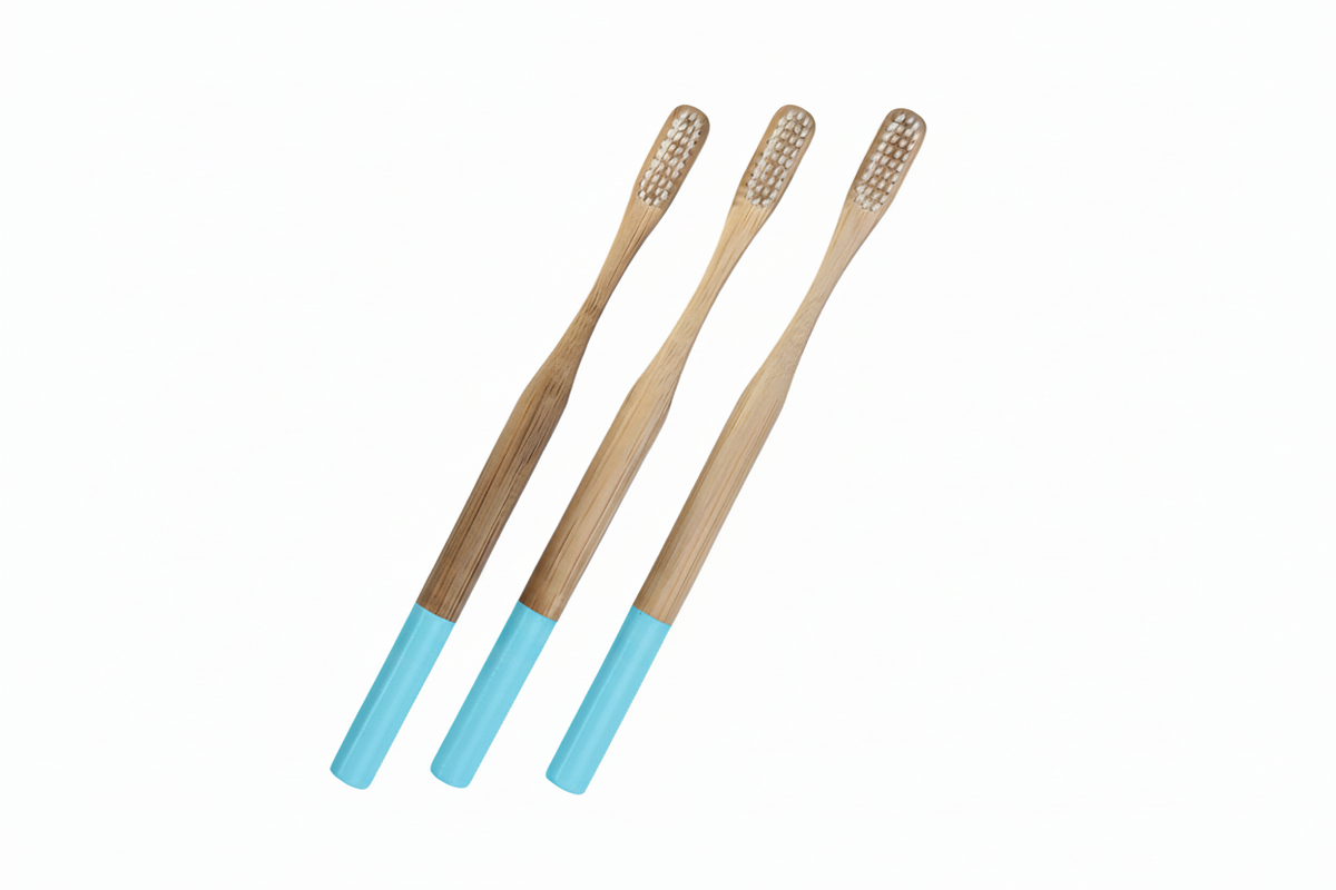 Three bamboo toothbrushes with light blue handles, arranged diagonally on a solid white background.