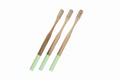 Three bamboo toothbrushes with mint green handles, arranged diagonally on a plain white background.