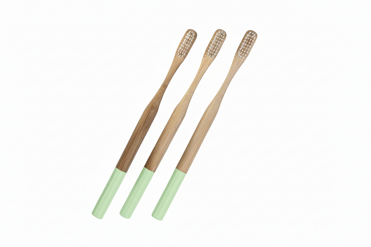 Three bamboo toothbrushes with mint green handles, arranged diagonally on a plain white background.